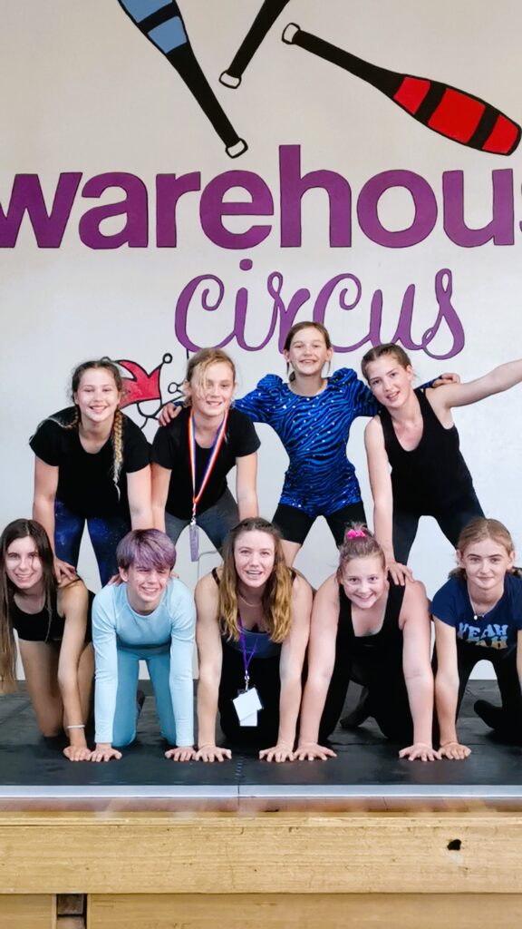 Roundabout Circus Troupe members form a pyramid at warehouse circus