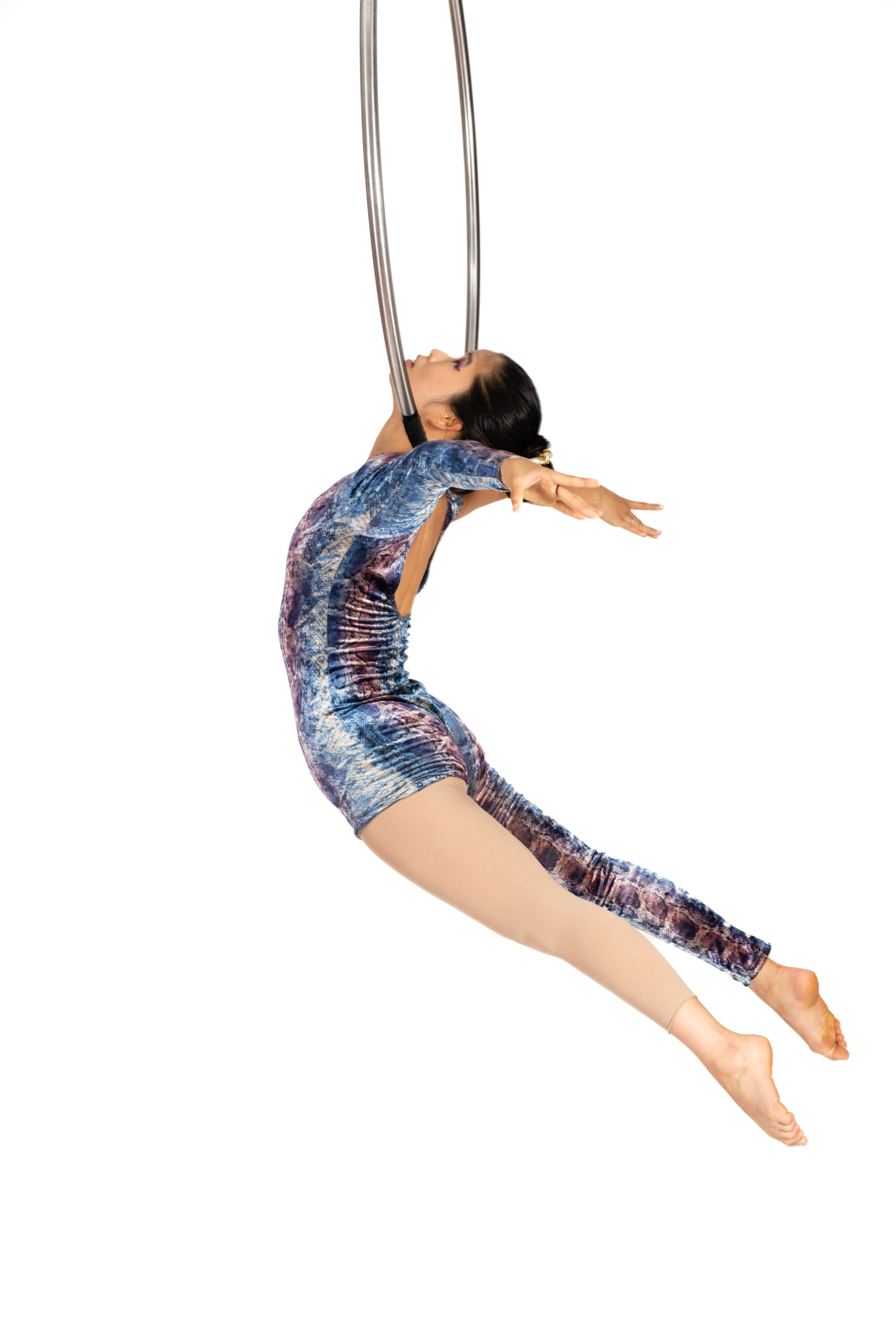 An advanced aerial student performs a neck hang from the Lyra at Roundabout Circus Studio in Wyoming