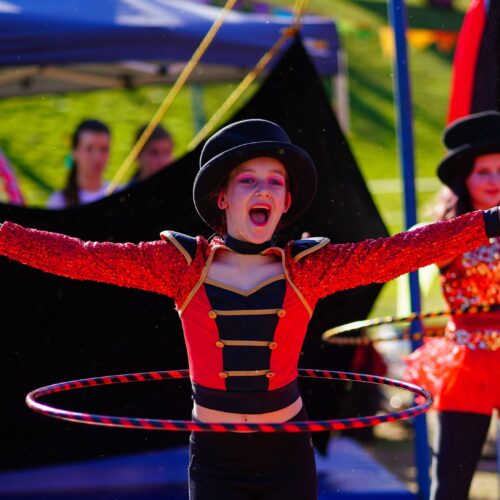 A hula hoop performer having a great time as The Greatest Showman for Roundabout Circus Performance Troupe at The Horses Birthday Kids Festival