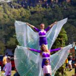 Beautiful stilt walkers perform and take photos with attendees of The Horses Birthday Kids Festival