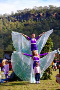 Beautiful stilt walkers perform and take photos with attendees of The Horses Birthday Kids Festival