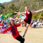 Members of our Youth Performance Troupe showcasing a challenging acrobatic skill, under the bright blue sky of the Central Coast at The Horses Birthday Glenworth Valley.
